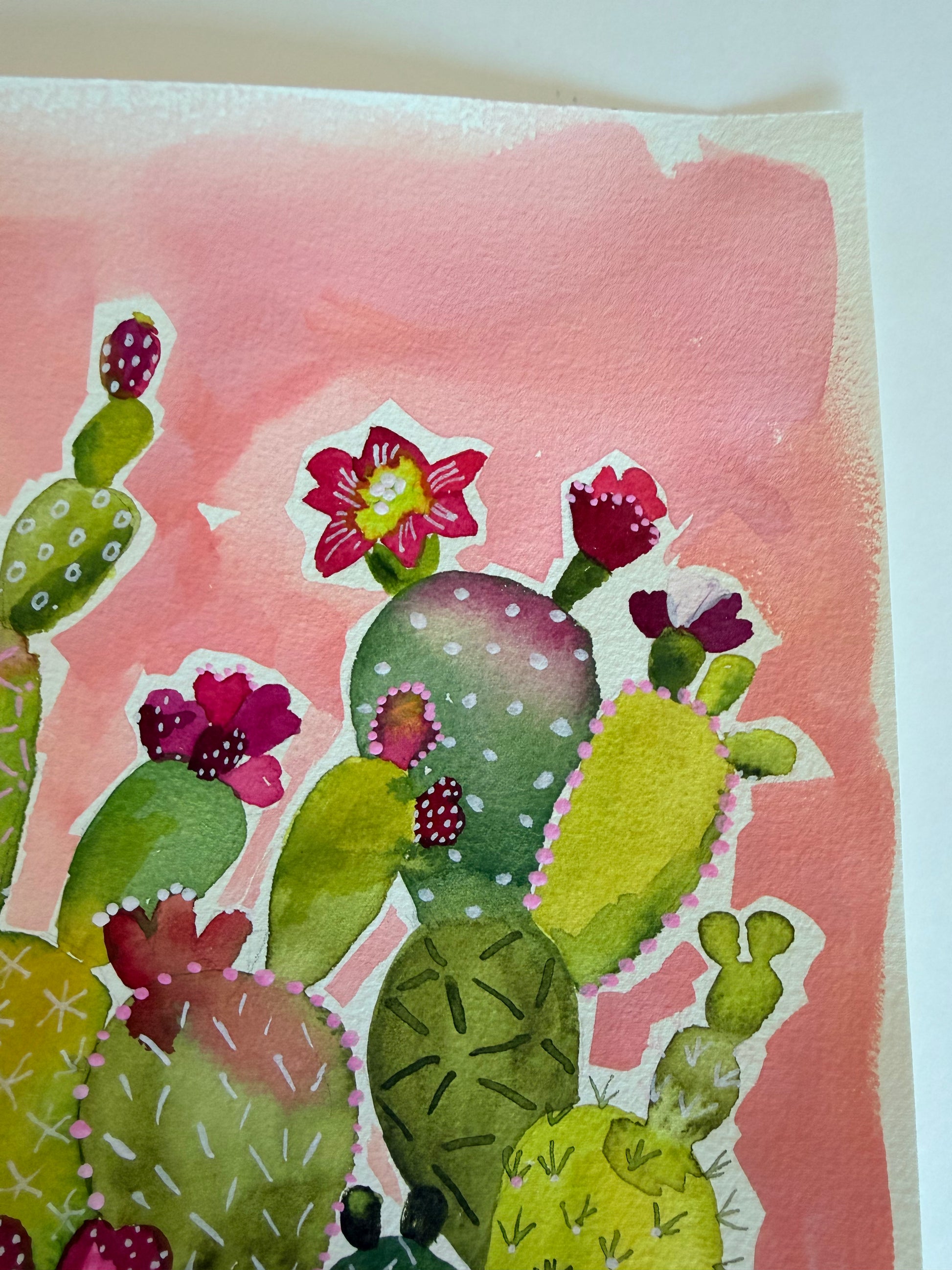 Watercolor painting of cacti with pink flowers on a pink background