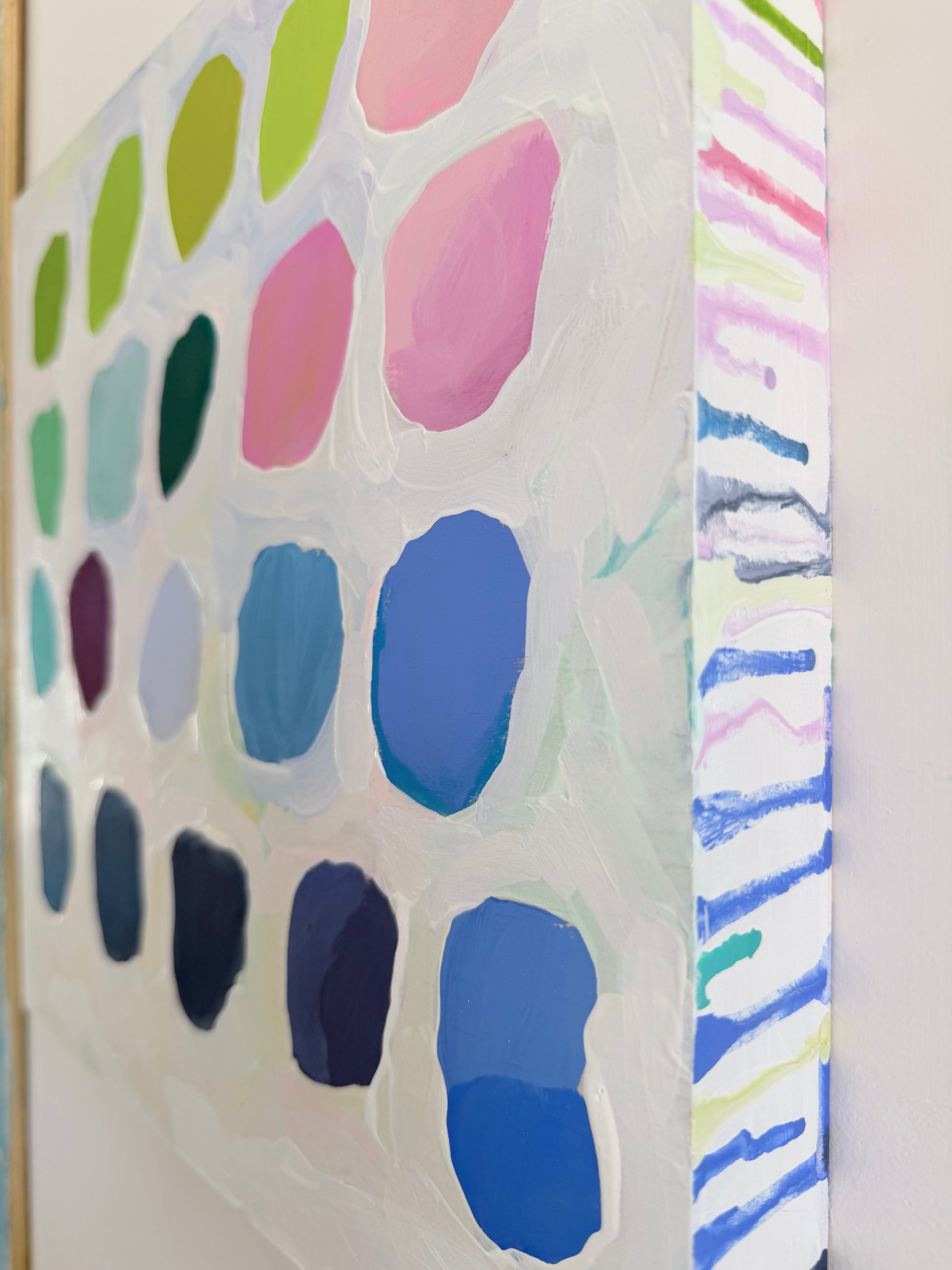 Color swatch with blue, green, pink, and purple paint samples on a white background