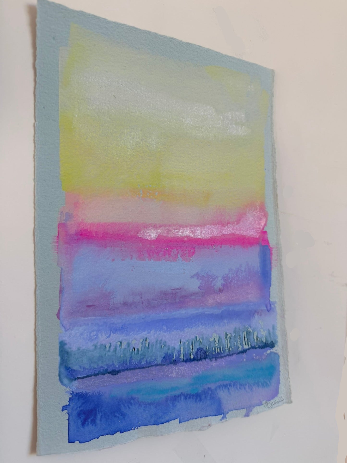 Abstract watercolor painting with horizontal stripes of yellow, pink, and blue on a white background.