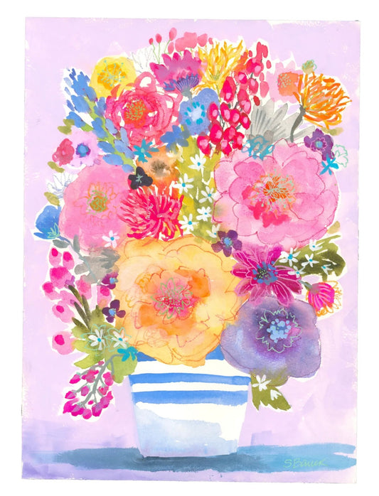 Colorful floral arrangement in a striped vase on a light purple background