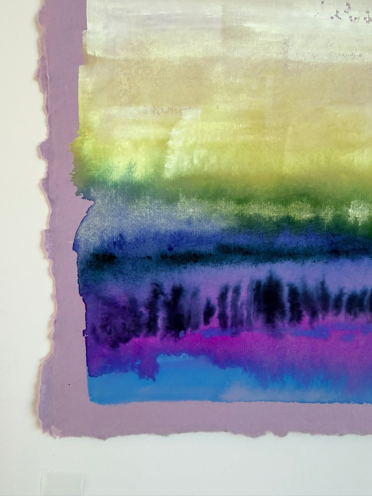 Colorful abstract watercolor painting with gradient of purple, blue, green, and yellow on a white background.
