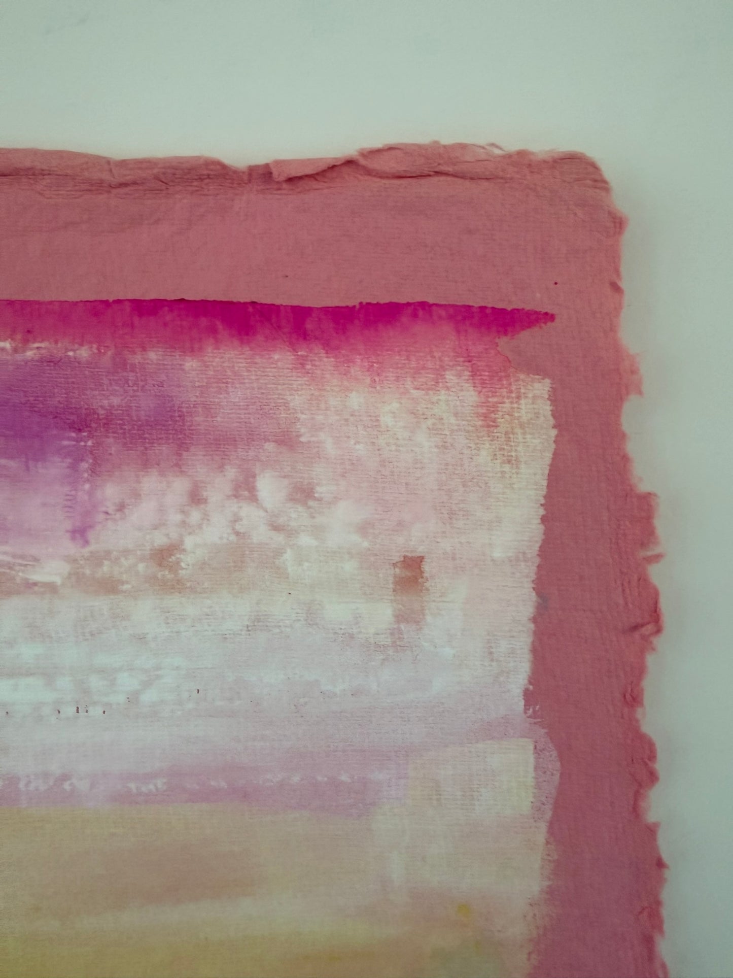 Textured paper with pink, purple, and white gradient on a white background