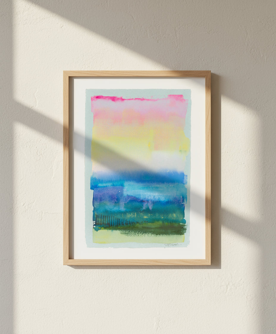 framed Abstract watercolor seascape painting with horizontal stripes in pink, yellow, blue, and green on a white background.