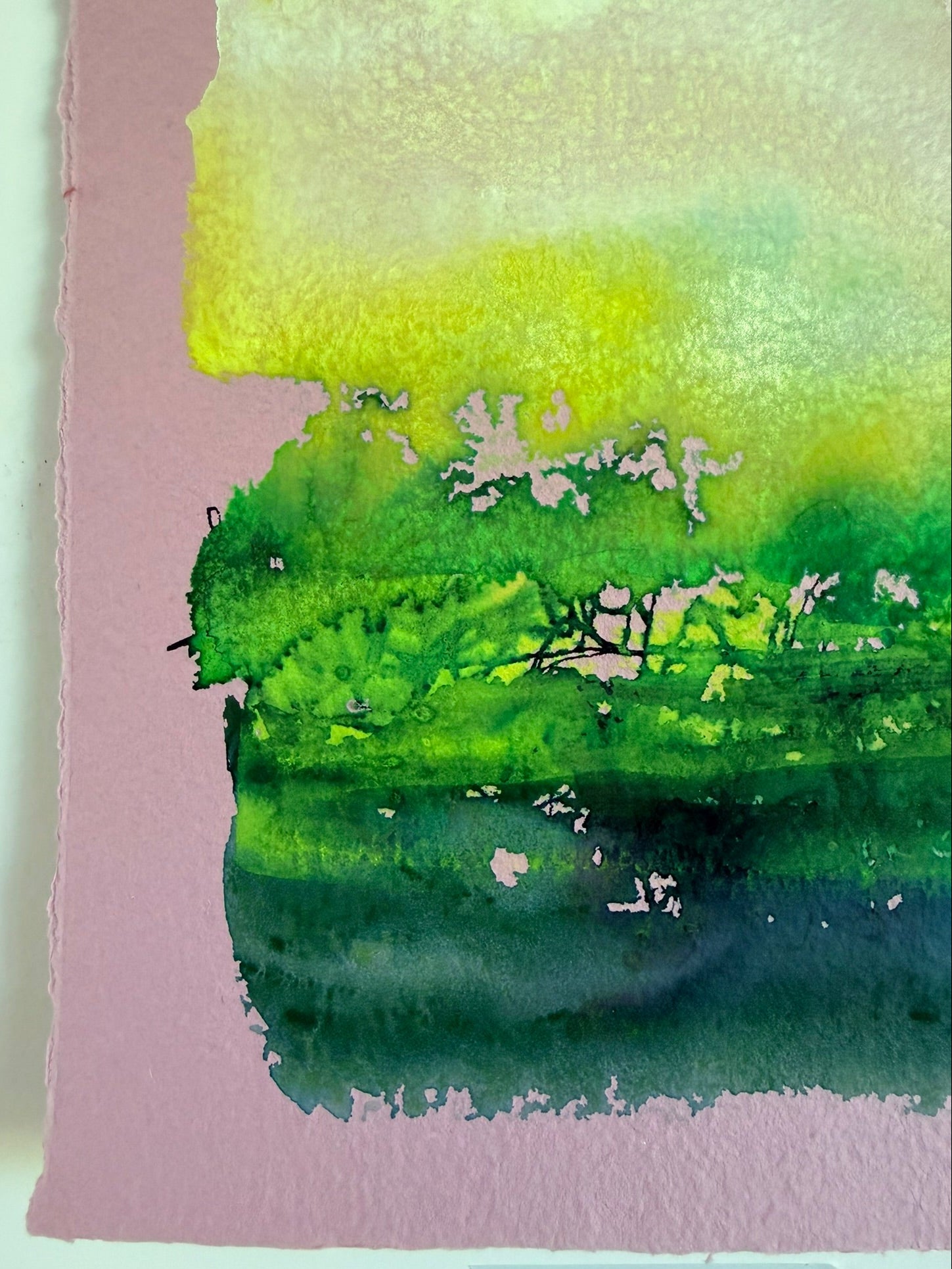 Abstract watercolor painting with green and pink hues on a white background
